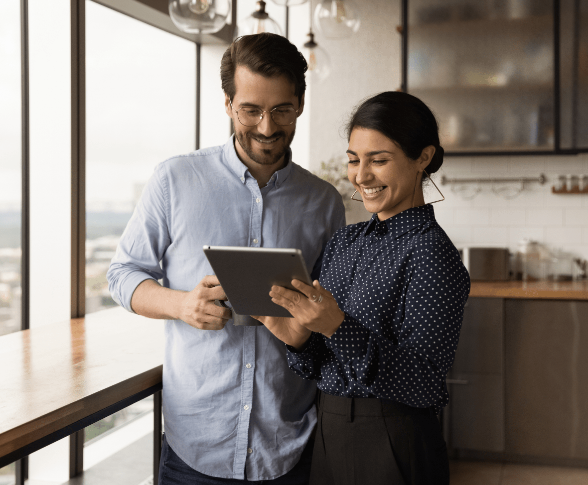 Couple watching a tablet in a kitchen