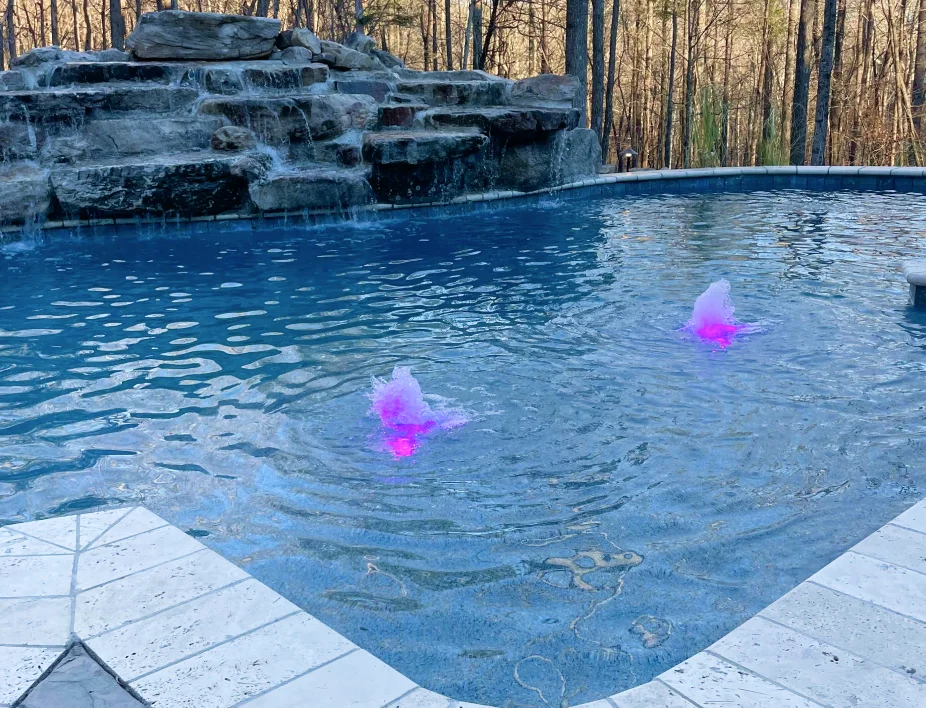 Swimming pool with stone waterfall