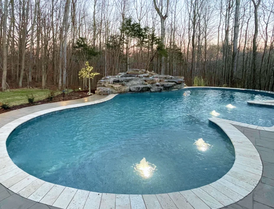 Swimming pool with stone waterfall