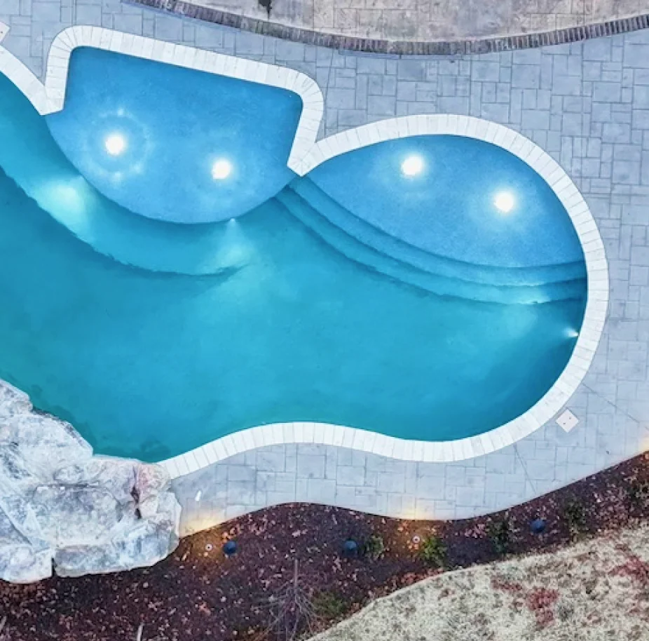 Aerial view of pool with lights in the background