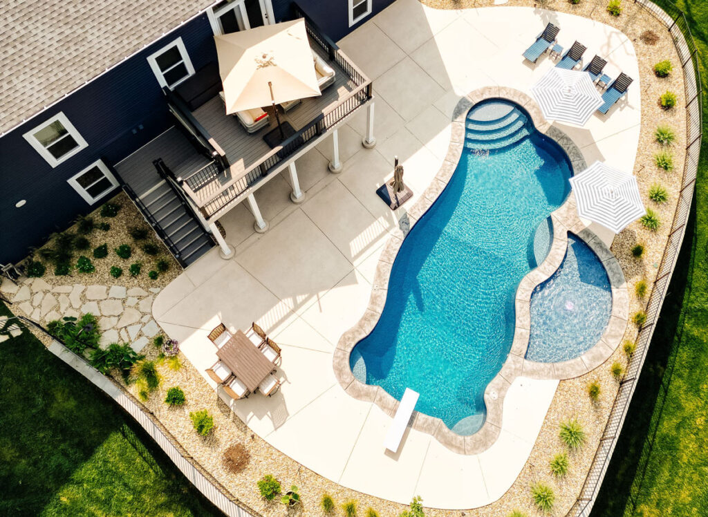 An aerial view of a backyard with an inground pool