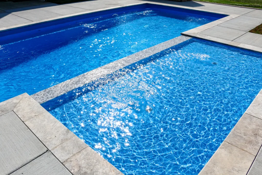 A pool with sunshine on the surface of the water