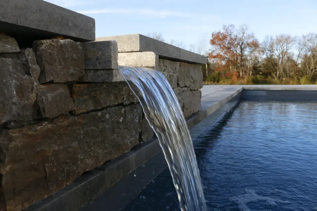A picture of a scupper leading water to come out into a lower pool on an outdoor pool