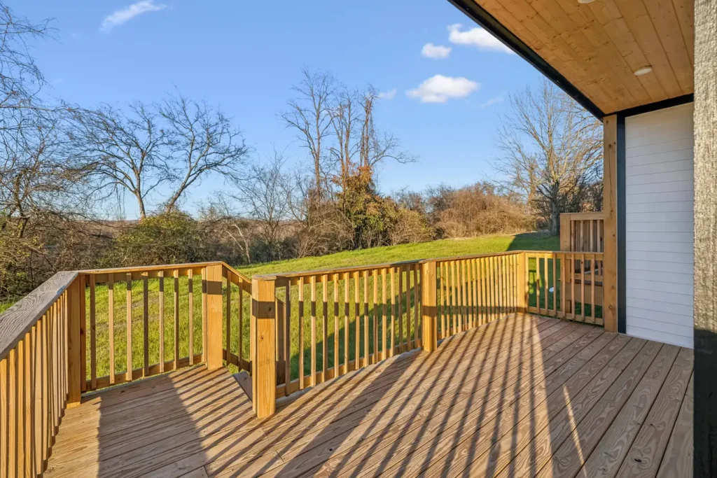 A picture of a backyard and deck of a home