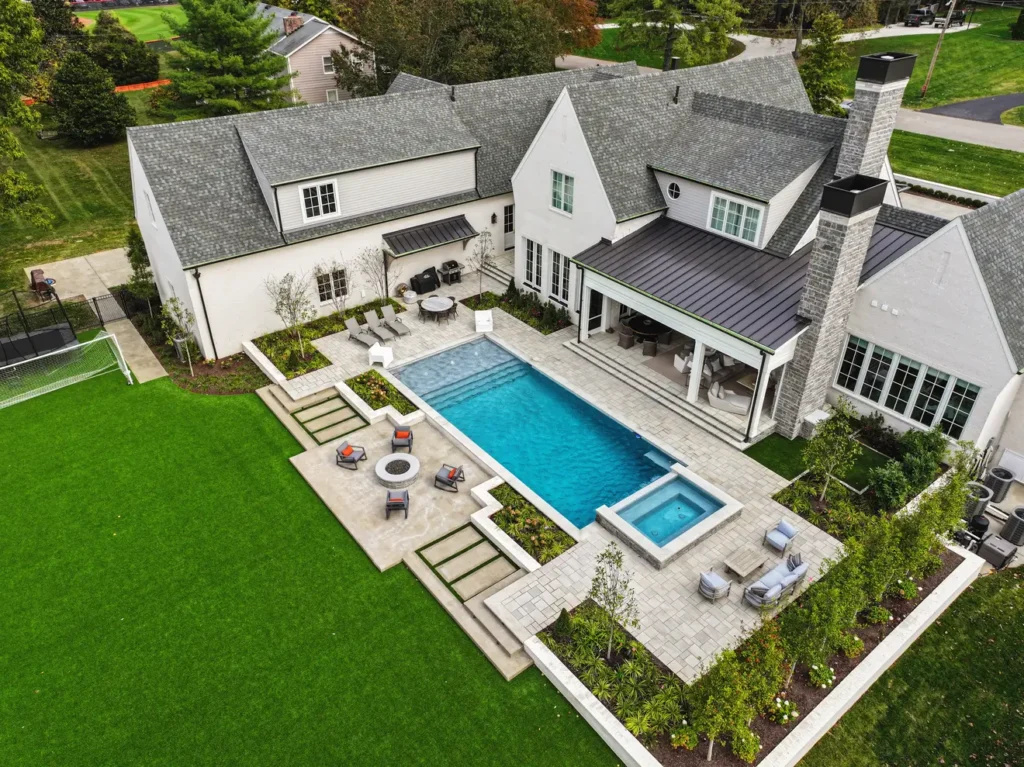 An aerial picture of a pool that has been well-maintained in a backyard