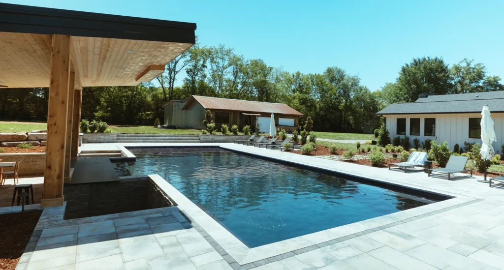 A pool with an outdoor structure above it