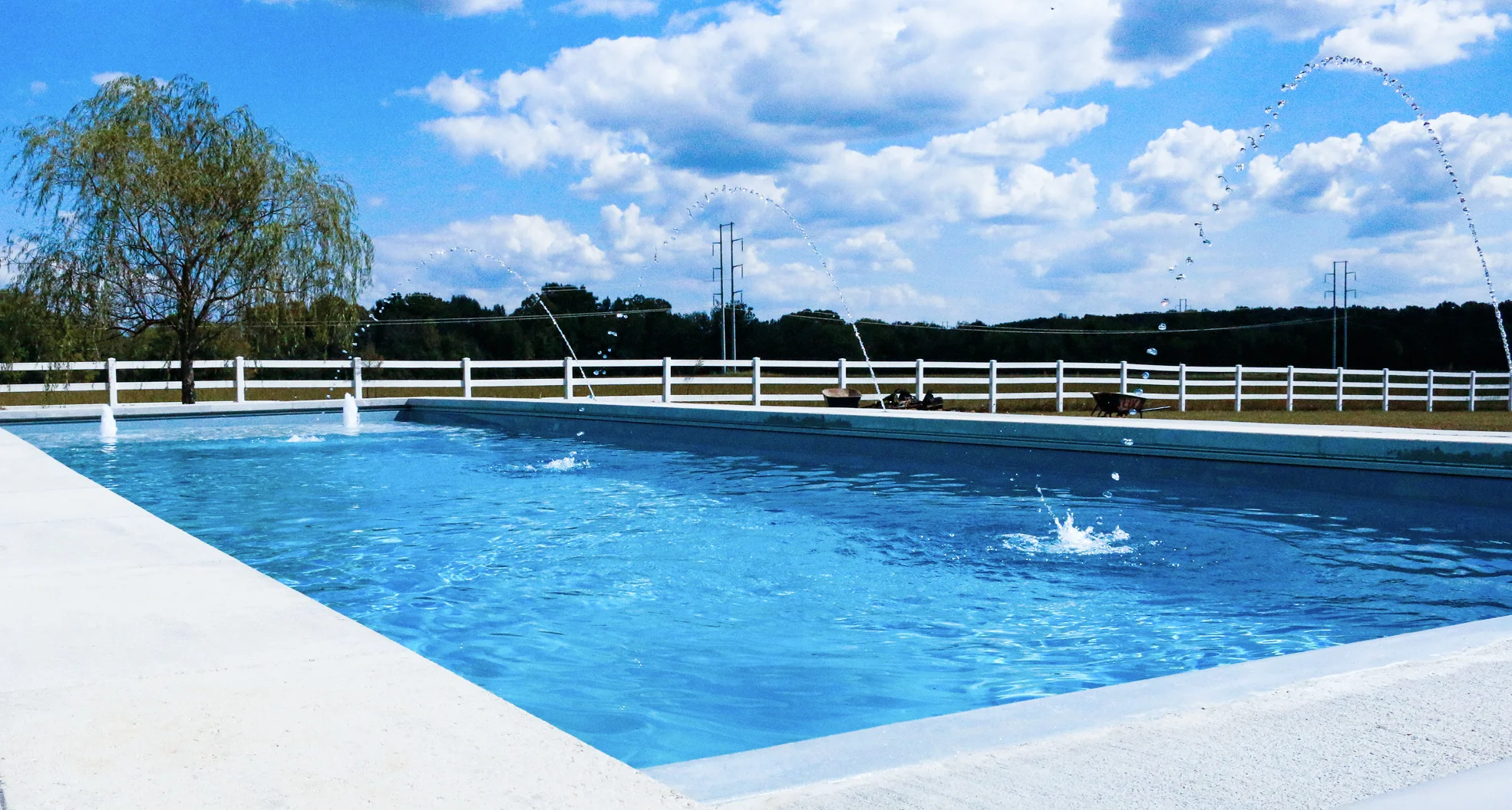 Fiberglass swimming pool with surrounding trees, showing a peaceful pool setting where swimmers must wait after shocking before re‑entering.