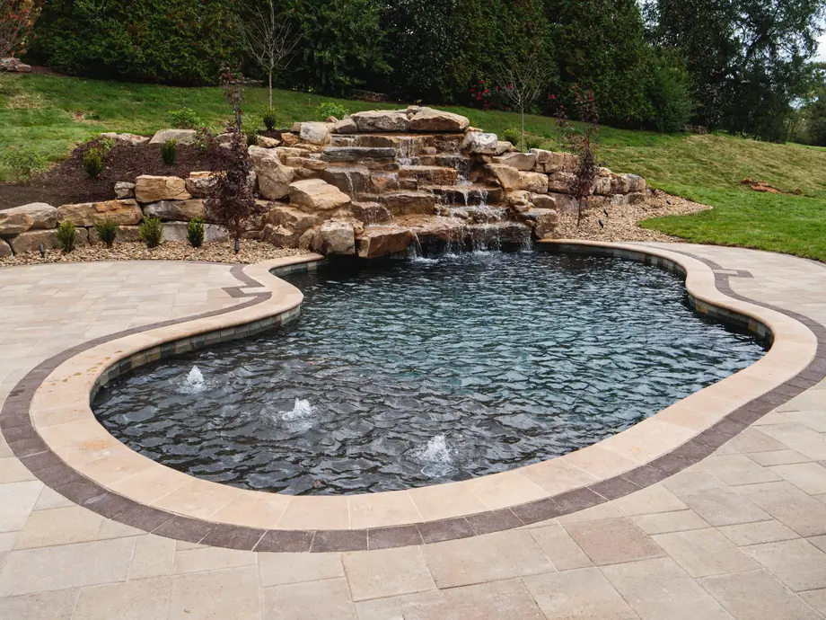 A picture of a swimming pool with a small babbling brook