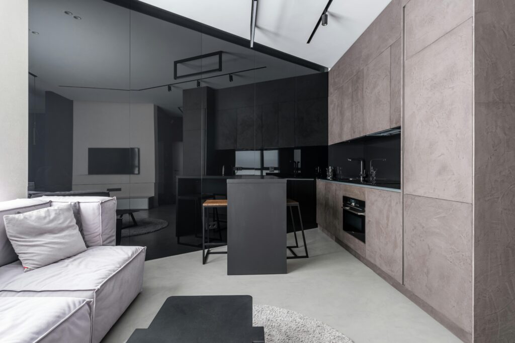A picture of a black and dark-toned kitchen